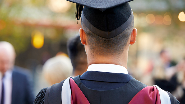 The back of a student's head during graduation.