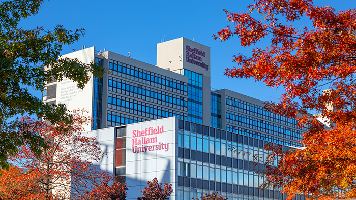 Owen Building, framed by vivid blue skies and autumnal leaves.