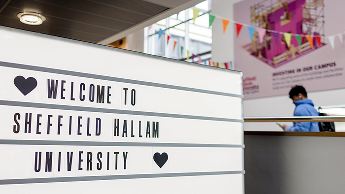 A sign in the entrance to Owen Building that reads Welcome To Sheffield Hallam University.