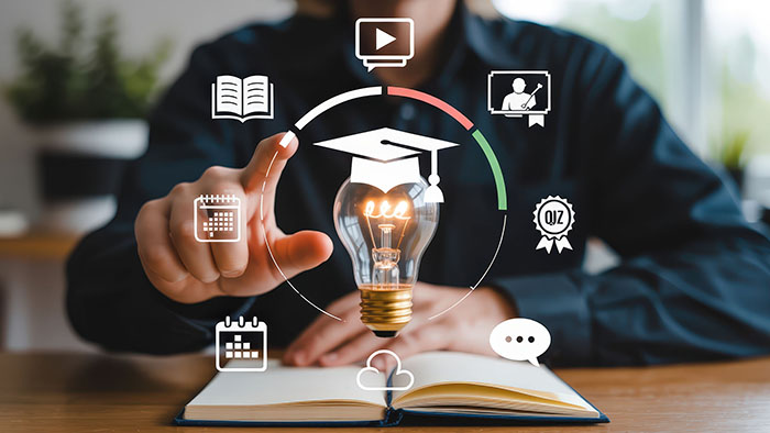 a student is tapping on some virtual icons, floating in the air above an open book
