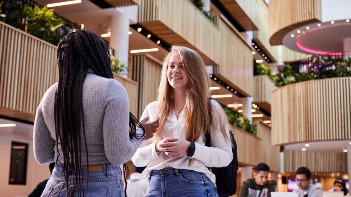 Two women talking in The Atrium